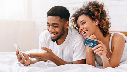 Couple buying online with smartphone and credit card