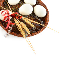 Chicken eggs in a wicker basket isolated on a white. There is free space for text. Vertical photo. - 781304146