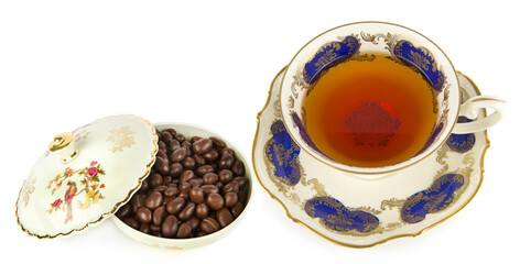 Tea in a vintage porcelain cup and chocolate dragee in a vintage candy bowl isolated on a white background. Collage.