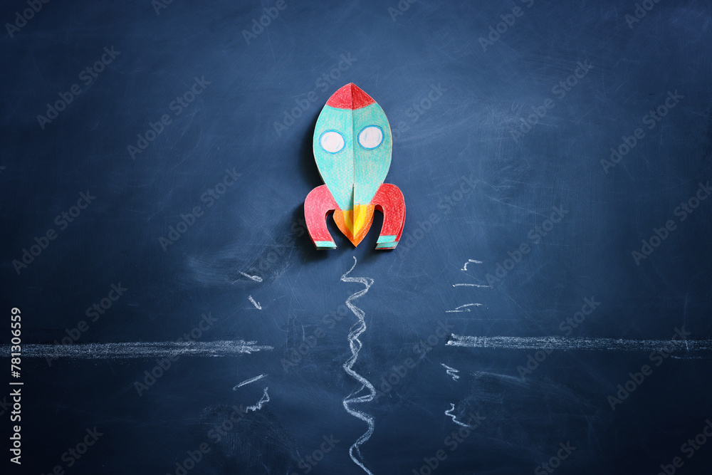 Poster rocket overcoming barrier obstacle. blackboard background