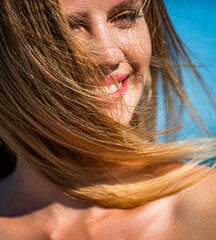 Woman smiling perfect smile.Woman flying hair enjoying, outdoor. Beauty blonde girl portrait at...