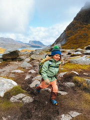 Child hiking in mountains adventure travel family vacations outdoor active healthy lifestyle, girl 4 years old kid with backpack exploring trails in Norway - 781312175