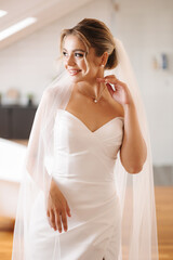 Portrait of gorgeous bride in beautiful wedding dress. Morning of bride