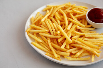 Fried French Fries with Ketchup on a Plate, side view. Copy space.