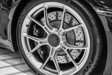 Close up Car alloy wheel and disc-brake sport car, black and white
