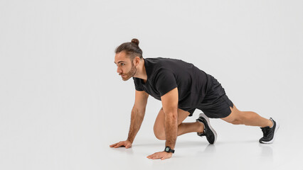 Man in black working out with lunge stance