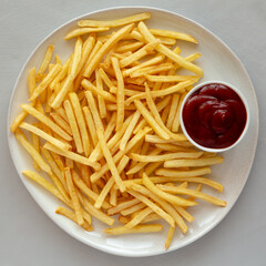Fried French Fries with Ketchup on a Plate, top view. Flat lay, overhead, from above. Close-up.