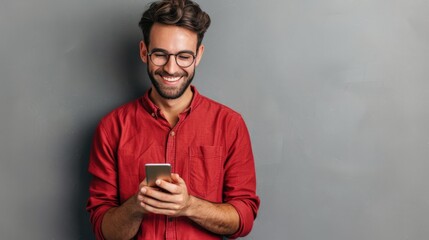 Man in red shirt holding cell phone