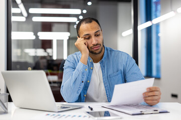 Indian businessman feeling stressed at office desk
