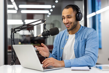 Indian man podcasting from home in a modern living room