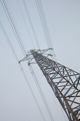 Electricity pylon against cloudy sky in winter, Haltiala, Helsinki, Finland.