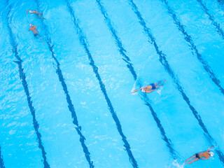 Group of People Swimming in a Pool
