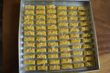 Top down view of crunchy Kaastengels cookies. Dutch influenced Indonesian cookies, popular during...