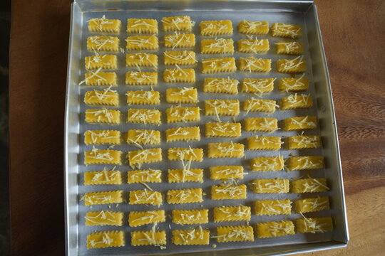 Top down view of crunchy Kaastengels cookies. Dutch influenced Indonesian cookies, popular during Eid Al Fitr in Indonesia