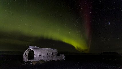 Aurora borealis, Northern lights.  plane Iceland. The Abandoned DC Plane on Solheimasandur