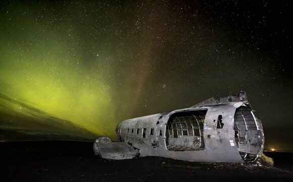 Aurora borealis, Northern lights.  plane Iceland. The Abandoned DC Plane on Solheimasandur