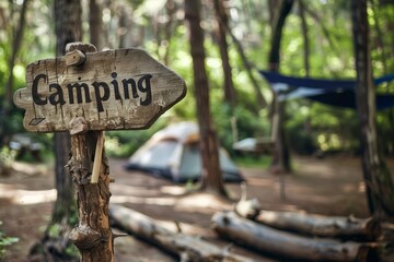 closeup view of a handcrafted wood directional campsite sign that says "Camping"