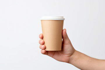 A person is holding a paper cup in their hand