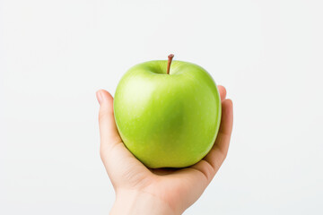 A hand holding a green apple