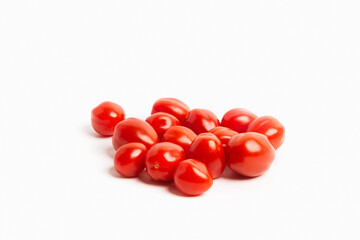 Small sweet cherry tomatoes on a white background. Isolated