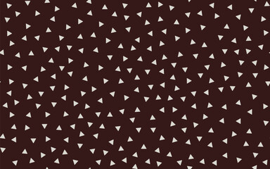 Small beige triangles isolated on a brown background. Seamless pattern. Random arrangement. Background for paper, cover, textile, dishes, interior decor.