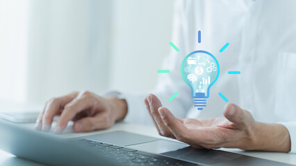 Businessperson working with glowing artificial intelligence light bulb. Business and financial success planning idea growth and solution. Marketing management intelligence strategy achievement