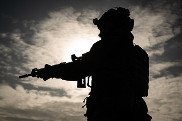 silhouette of a man holding a rifle
