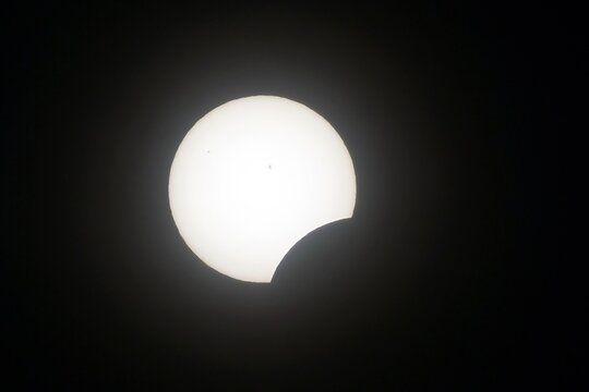 The view of a partial solar eclipse during the North American eclipse of 2024. Sun spots are visible.