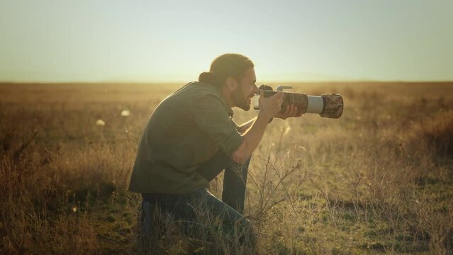 Wildlife photographer tourist taking pictures in wild desert nature.