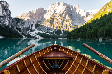 View of wooden boat on Lake di Braies with beautiful mountains in the background, Dolomites. Italy - obrazy, fototapety, plakaty
