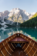 View of wooden boat on Lake di Braies with beautiful mountains in the background, Dolomites. Italy