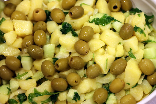 Boiled potato and green olive salad. Mediterranean food