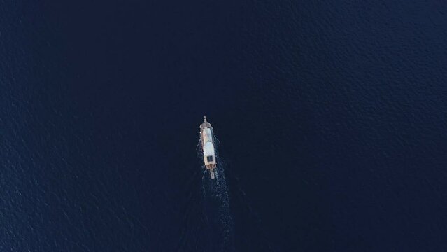 Top view of small boat sailing in the sea. Blue sea surface with speedboat