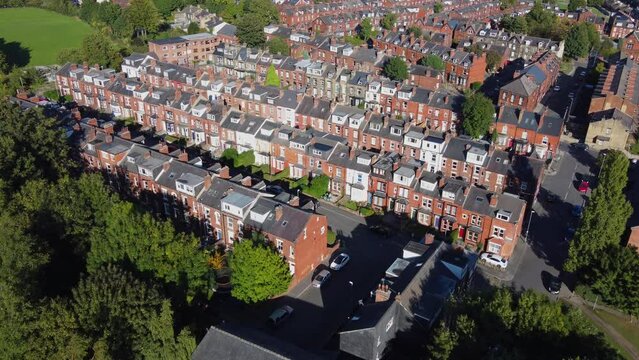 Aerial drone footage of the village of Headingley in Leeds, West Yorkshire in the UK showing the rows of houses in the residential area in the British town in the summer time