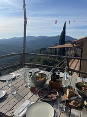 Lunch in Italy with the view of tuscan mountains, on the table is beef pecorino cheese wine and...