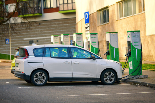 Minsk, Belarus. Apr 7, 2024. Bestune NAT electric mid-size multi purpose vehicle, MPVproduced by the FAW Group. Two chinese electric car charging battery at electric charger, charging station