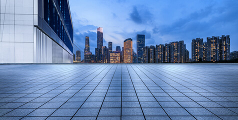 Empty square floors and city skyline with modern buildings at night in Guangzhou. Panoramic view.