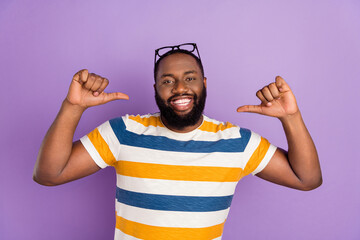 Photo of cool funky man wear striped t-shirt showing thumbs himself isolated violet color background