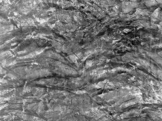 Cracked old concrete wall covered with cement surface and texture as background. Abstract grunge brush stroke wall. Natural pattern. Texture of a concrete surface. Grunge mortar wall black and white.