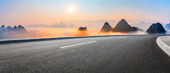 Fototapeta na wymiar Asphalt highway road and karst mountain with sky clouds natural landscape at sunrise. Panoramic view.