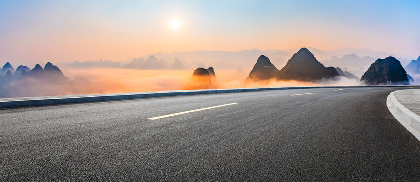 Asphalt highway road and karst mountain with sky clouds natural landscape at sunrise. Panoramic view.