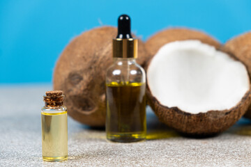 Obraz na płótnie Canvas Coconut oil in a small glass bottle for skin and hair care.