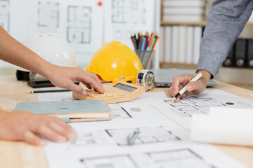 Architects at a meeting discussing house plans are reviewing draft house plans. Projects assigned...