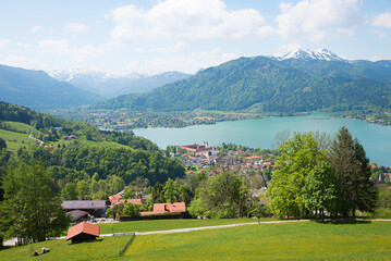 view from hiking route Neureuth, above lake Tegernsee and castle, spring landscape bavarian alps