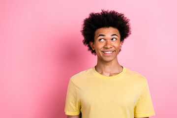 Portrait of nice young man think look empty space wear yellow t-shirt isolated on pink color...