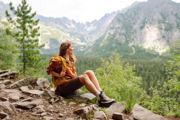 Woman traveler enjoying beautiful view of mountains. Beautiful mountains landscape view. Lifestyle,...