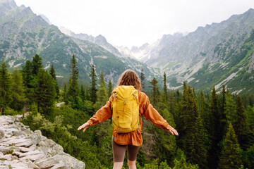 Woman traveler enjoying beautiful view of mountains. Beautiful mountains landscape view. Lifestyle,...