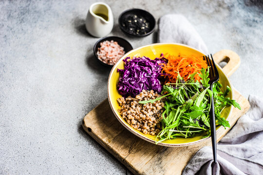 Healthy food for losing weight with salad leaves mix and raw vegetables
