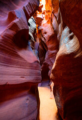 Colorful sandstone formations in a slot canyon, a natural attraction in Arizona USA. Gently eroded rock forms imaginative shapes and plays of light and shadow in shades of red, orange, brown, yellow