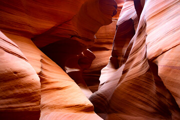 Antelope canyon in Arizona, USA ist a natural wonder, magic place and tourist attraction formed by the power of erosion. Red-orange sandstone washed out by water in colorul shapes illuminated by sun.